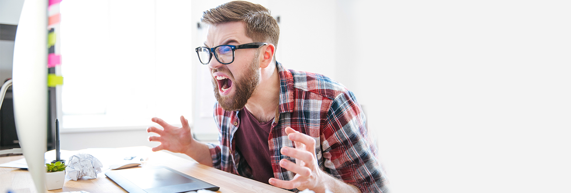 man screaming at his computer in frustration to Facebook zero